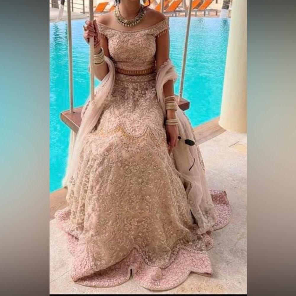 Light peach/pink off shoulder lehnga with dull gold handwork